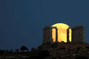Prints of People watch a full moon rising behind the Temple of Poseidon before a lunar eclipse in Cape Sounion, near Athens, Greece, July 27, 2018. REUTERS/Alkis Konstantinidis TPX IMAGES OF THE DAY Eclipse Prints: Print of Lunar Eclipse in Greece