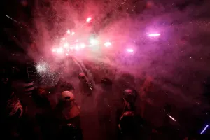 Prints of Participators wearing motorcycle helmets get sprayed with firecrackers, during the Beehive Firecrackers festival at the Yanshui district in Tainan, Taiwan March 2, 2018. REUTERS/Tyrone Siu Tyrone Prints: Print of people in motorcycle helmets sprayed with firecrackers