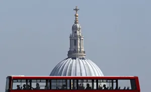 Passengers travel on the top deck of a bus as it is driven past St Pauls Cathedral Passengers travel on the top deck of a bus as it is driven past St Pauls Cathedral