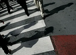 Pedestrians cross the road on a zebra crossing in the Shibuya shopping district in Tokyo Pedestrians cross the road on a zebra crossing in the Shibuya shopping district in Tokyo
