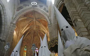 Penitents take part in the procession of La Borriquita brotherhood during Holy Week in Penitents take part in the procession of La Borriquita brotherhood during Holy Week in