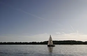 People sail along Talty Lake close to Mikolajki in the Masurian Lake District People sail along Talty Lake close to Mikolajki in the Masurian Lake District