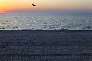 People stroll on the beach at the dawn in the Black Sea resort of Mamaia People stroll on the beach at the dawn in the Black Sea resort of Mamaia