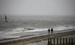 People walk on a beach at the North Sea in Cuxhaven People walk on a beach at the North Sea in Cuxhaven