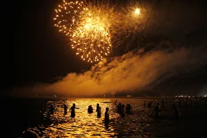 People watch fireworks as they take a bath in the Mediterranean Sea on San Juan's People watch fireworks as they take a bath in the Mediterranean Sea on San Juan's