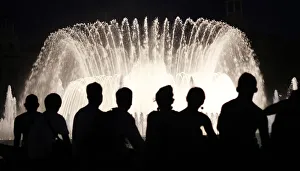 People watch the Font Magica de Montjuic (Magic Fountain of Montjuic) show in Barcelona People watch the Font Magica de Montjuic (Magic Fountain of Montjuic) show in Barcelona