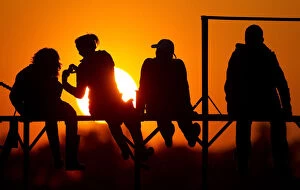 Images Dated 5th May 2013: People watch the sunset on the banks of river Pripyat in the town of Turov