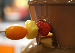 Pieces of fruits are coated with chocolate during the 2nd Chocolate Fair of Barcelona Pieces of fruits are coated with chocolate during the 2nd Chocolate Fair of Barcelona