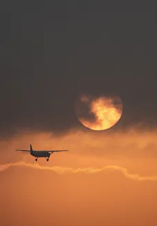 Plane flies during sunrise in the early hours in Bogota Plane flies during sunrise in the early hours in Bogota