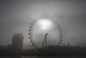 The pods on the London Eye casts shadows against a thick morning fog as the spring The pods on the London Eye casts shadows against a thick morning fog as the spring