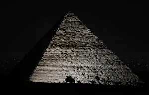 A police car is seen in front of the Great Pyramids in Giza, on the outskirts of Cairo A police car is seen in front of the Great Pyramids in Giza, on the outskirts of Cairo