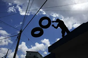 A police officer seizes tyres that protesters use for burning A police officer seizes tyres that protesters use for burning