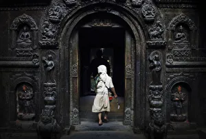 A priest enters the premises of a temple to offer daily prayers in Lalitpur A priest enters the premises of a temple to offer daily prayers in Lalitpur