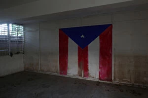 Images Dated 6th February 2018: The Puerto Rican flag is seen on the wall of a class room of a shut-down elementary