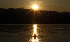 A rower is seen during sunset on Lake Zurich on a mild and sunny spring day near Kuesnacht A rower is seen during sunset on Lake Zurich on a mild and sunny spring day near Kuesnacht