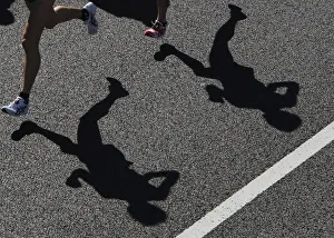 Runners cast their shadows during the 2008 Tokyo Marathon Runners cast their shadows during the 2008 Tokyo Marathon