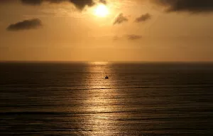 Images Dated 29th November 2017: A sailboat sails during sunset in the Pacific Ocean in Lima