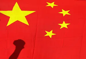 Shadow of clenched fist of protester is seen on Chinese national flag during anti-Japan Shadow of clenched fist of protester is seen on Chinese national flag during anti-Japan