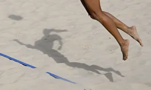 The shadow of a volleyball player is pictured as she hits the ball The shadow of a volleyball player is pictured as she hits the ball