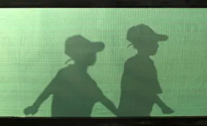 The silhouettes of Palestinian boys are seen as they arrive for a summer camp organised The silhouettes of Palestinian boys are seen as they arrive for a summer camp organised