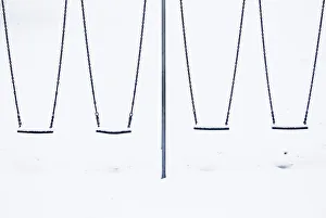 Snow sits on childrens swings at a playground in Lyminge near Folkestone in southern Snow sits on childrens swings at a playground in Lyminge near Folkestone in southern