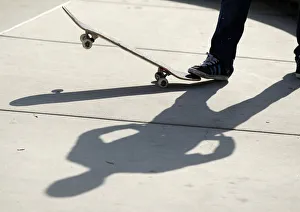 SPORT SKATEBOARDING A skateboarder casts a shadow on the conrete SPORT SKATEBOARDING A skateboarder casts a shadow on the conrete