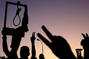 A Sudanese demonstrator carries a noose and gestures during a mass anti-government A Sudanese demonstrator carries a noose and gestures during a mass anti-government