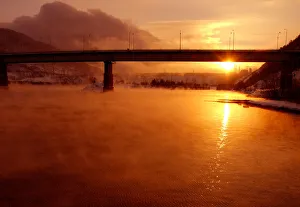 The sun sets over the Yenisey River near the hydroelectric power station by the town The sun sets over the Yenisey River near the hydroelectric power station by the town