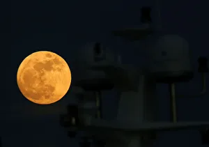 A supermoon full moon rises behind the antennae domes on a motor yacht in Pieta A supermoon full moon rises behind the antennae domes on a motor yacht in Pieta