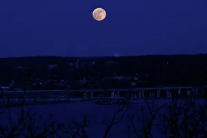 A supermoon full moon is seen above the Hudson River and the Mario M A supermoon full moon is seen above the Hudson River and the Mario M