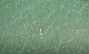 A surfer swims at Barra da Tijuca beach in Rio de Janeiro A surfer swims at Barra da Tijuca beach in Rio de Janeiro
