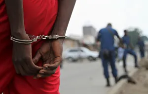 A suspect is handcuffed and detained by policemen after a grenade attack of Burundi's A suspect is handcuffed and detained by policemen after a grenade attack of Burundi's