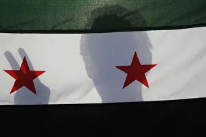 A Syrian protester holds a Syrian opposition flag during a demonstration A Syrian protester holds a Syrian opposition flag during a demonstration
