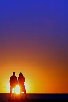 Two teenagers observe the sunrise over River Plate in Montevideo Two teenagers observe the sunrise over River Plate in Montevideo