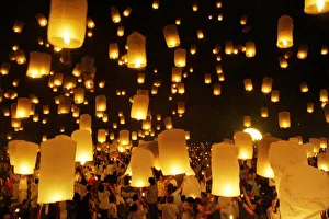 Thais gather to release floating lanterns at Homage to the Lord Buddha during the Thais gather to release floating lanterns at Homage to the Lord Buddha during the