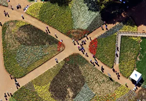 Tourists walk on pathways through the Floriade flower festival in Canberra Tourists walk on pathways through the Floriade flower festival in Canberra