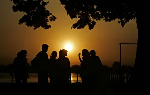 Tourists watch sun sets over Kashmirs Dal Lake in Srinagar Tourists watch sun sets over Kashmirs Dal Lake in Srinagar