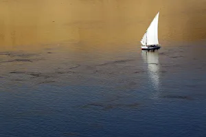 Traditional Egyptian Felucca boat sails on the Nile river in the southern Egyptian Traditional Egyptian Felucca boat sails on the Nile river in the southern Egyptian
