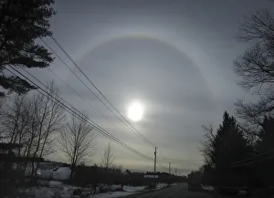 Truck drives down a highway as a sun dog appears in the sky as seen from Fort Ann in Truck drives down a highway as a sun dog appears in the sky as seen from Fort Ann in