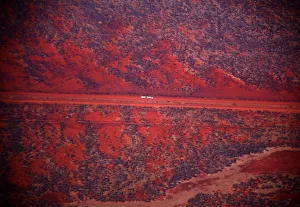 A truck drives along a road in the Pilbara region of Western Australia A truck drives along a road in the Pilbara region of Western Australia