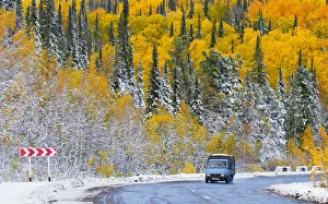 A van drives on a road through a snow covered forest near the Siberian village of A van drives on a road through a snow covered forest near the Siberian village of
