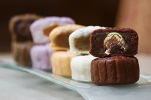 A variety of mooncakes with different fillings are displayed for the camera at a hotel A variety of mooncakes with different fillings are displayed for the camera at a hotel