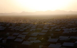 Nairobi Collection: A vehicle drives at dusk within recently constructed houses at the Kakuma refugee camp in