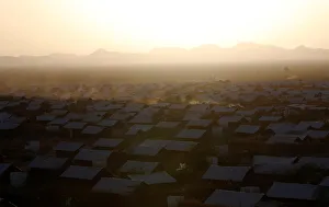 A vehicle drives at dusk within recently constructed houses at the Kakuma refugee camp in A vehicle drives at dusk within recently constructed houses at the Kakuma refugee camp in