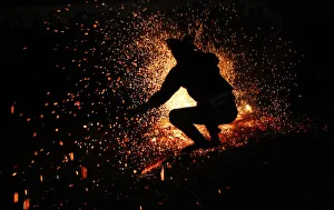 A Vietnamese man from the Pa Then minority group jumps into a fire during a ritual A Vietnamese man from the Pa Then minority group jumps into a fire during a ritual