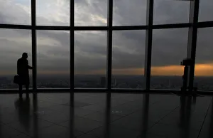 A visitor is silhouetted at an observation deck in Tokyo A visitor is silhouetted at an observation deck in Tokyo
