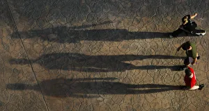 Visitors cast shadows as they walk inside a vast airship hangar hosting a Tropical Visitors cast shadows as they walk inside a vast airship hangar hosting a Tropical
