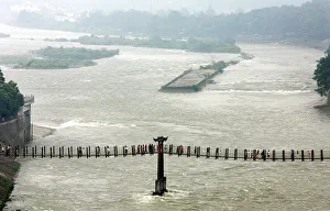 Visitors cross a cable bridge over Minjiang River in Chinas Dujiangyan Visitors cross a cable bridge over Minjiang River in Chinas Dujiangyan