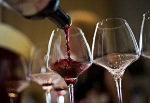 A waiter serves a glass of red wine from Spain during a tasting session at Vinexpo A waiter serves a glass of red wine from Spain during a tasting session at Vinexpo