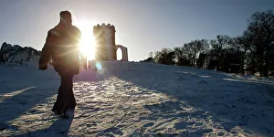 A WALKER STRIDES THROUGH SNOW TOWARDS THE OLD JOHN MEMORIAL IN BRADGATE PARK A WALKER STRIDES THROUGH SNOW TOWARDS THE OLD JOHN MEMORIAL IN BRADGATE PARK